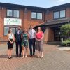 Group of people outside an Exeter office