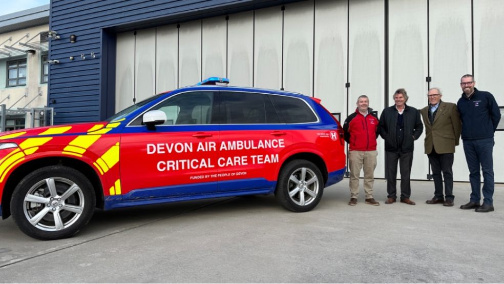 Picture of 4 men standing next to a Devon Air Ambulance critical care car